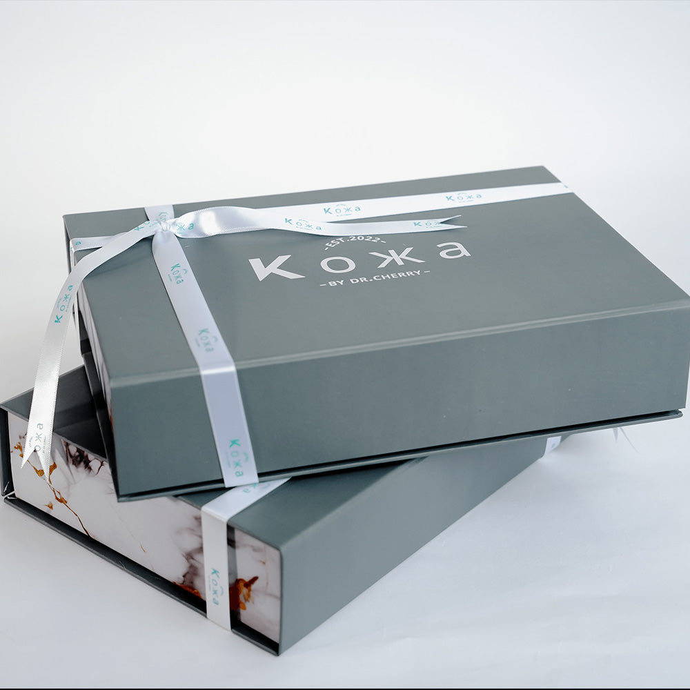 Koxa by Dr. Cherry packaging with a ribbon on a white background